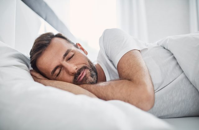 man sleeping in bed